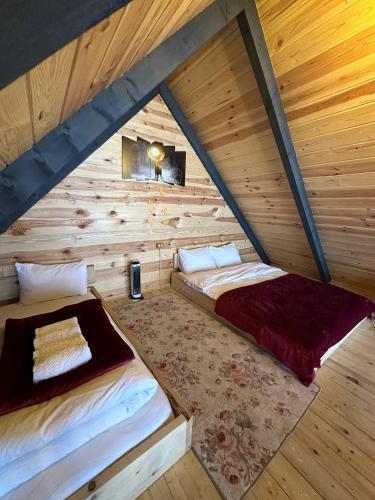 1 dormitorio con 2 camas en una cabaña de madera en Zekeriyaköy Dağ evi, en Rize