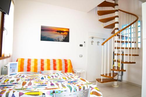 a bedroom with a bed and a staircase at Residence Eden in Comacchio