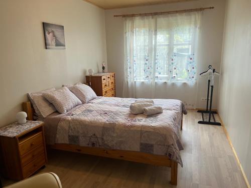 a bedroom with a bed with a dresser and a window at Papli Apartment near the Beach in Pärnu