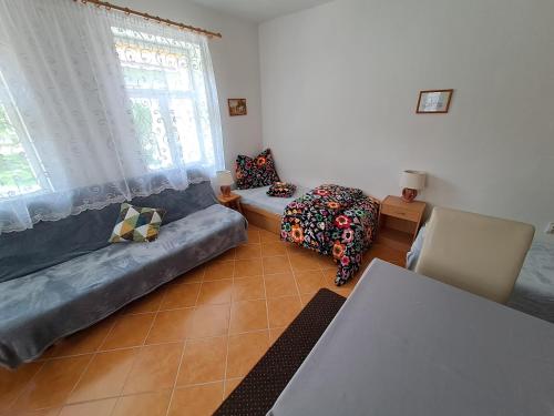 a living room with a couch and a table at Chalupa u Dionýza in Rejdová