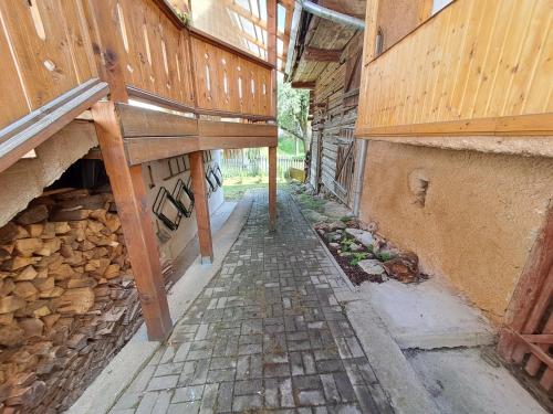 an empty alley with a wooden bench on the side of a building at Chalupa u Dionýza in Rejdová