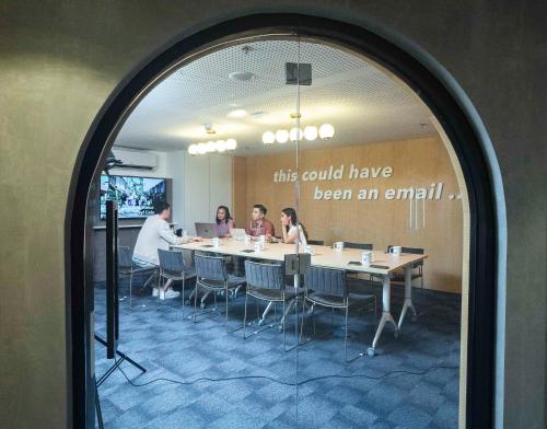 a group of people sitting around a table in a room at lyf Cebu City managed by The Ascott Limited in Cebu City