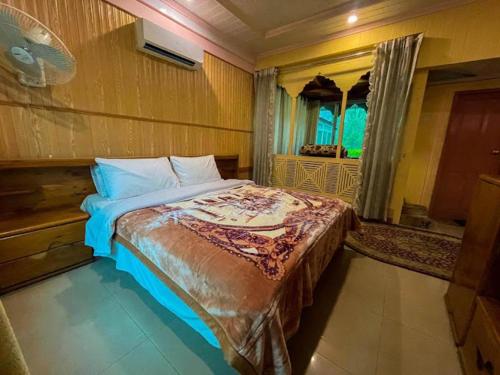 a bedroom with a large bed in a room at Canopy Nexus Resort Over The River in Gilgit