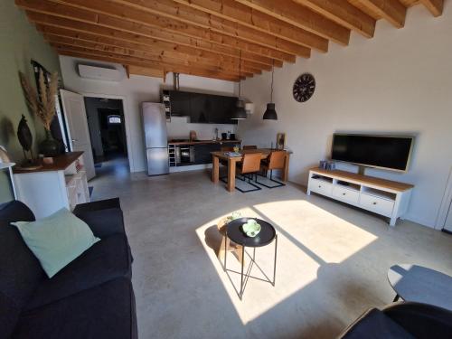 a living room with a couch and a table at De Varkensstal in De Heurne