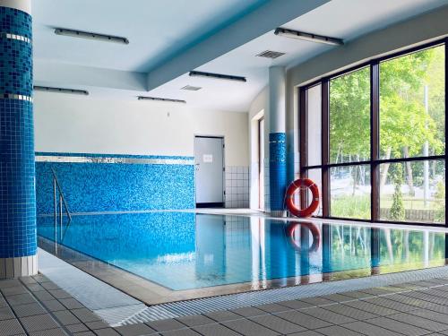 a swimming pool with a red ring in the middle at Yacht Club Residence Sopot in Sopot