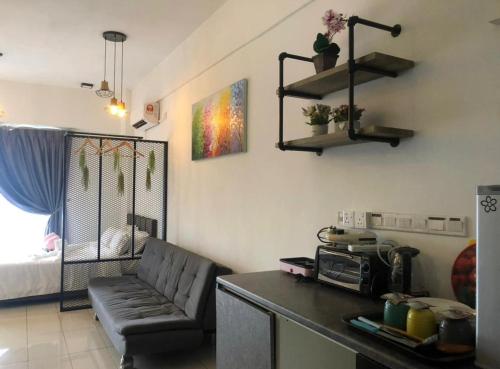a kitchen with a couch and a table in a room at Aeropod 5 mins to Airport 10 mins to KK city in Kota Kinabalu