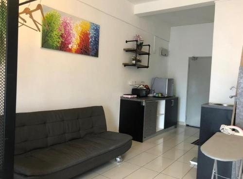 a living room with a couch and a table at Aeropod 5 mins to Airport 10 mins to KK city in Kota Kinabalu