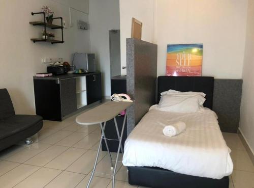 a room with a bed and a desk in it at Aeropod 5 mins to Airport 10 mins to KK city in Kota Kinabalu