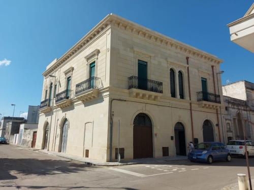 a building with a car parked in front of it at Palazzo San Francesco in Scorrano