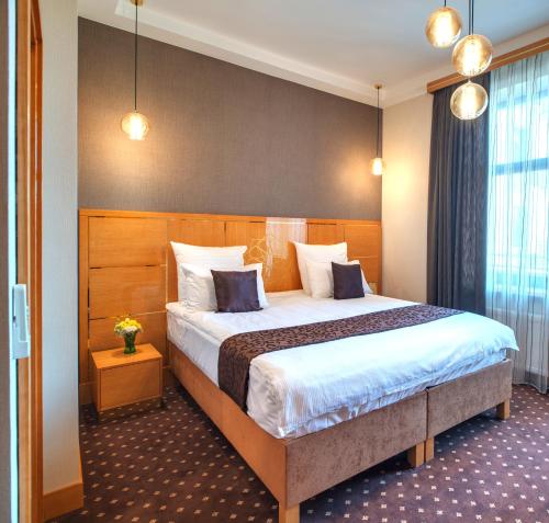 Кровать или кровати в номере Ark Palace Hotel & SPA