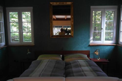 a bedroom with two beds and a mirror on the wall at Presshaus Alte Mühle in Stainz