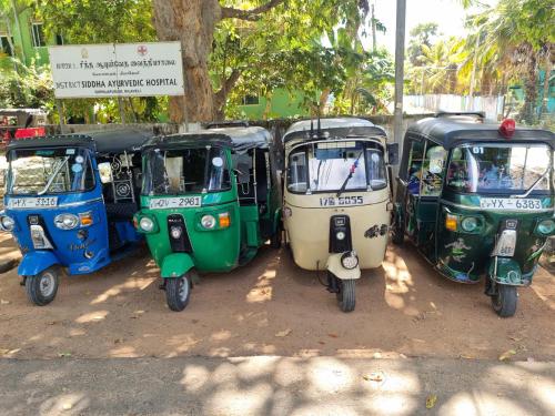 a group of three scooters parked next to each other at Nilaveli Guest House in Nilaveli