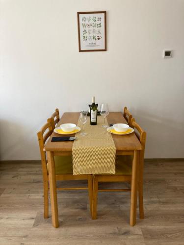 a wooden table with two glasses and a bottle of wine at Apartmán Karo, Oščadnica in Oščadnica