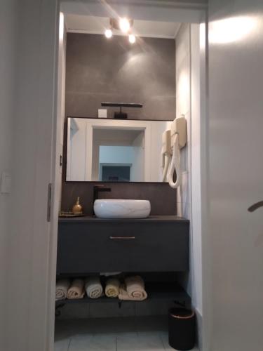 a bathroom with a sink and a mirror at Apartment Erceg in Poreč
