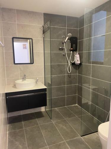 a bathroom with a shower and a sink at Indah@Antara Putrajaya in Putrajaya