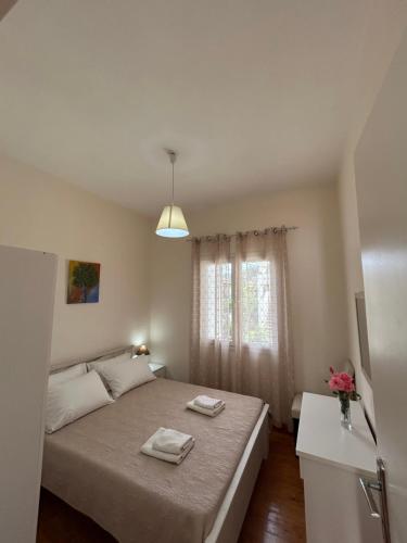 a bedroom with a bed with two towels on it at Agathis in Kassiopi