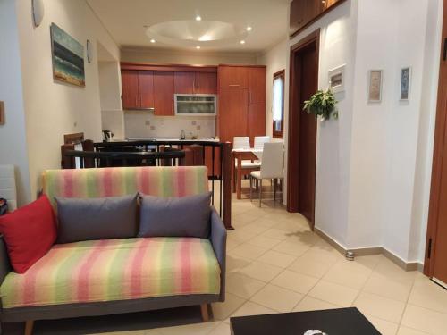 a living room with a couch and a kitchen at Seafront dream Villa, Ierissos in Ierissos