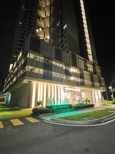 a building with an akiba hotel at night at Indah@Antara Putrajaya in Putrajaya