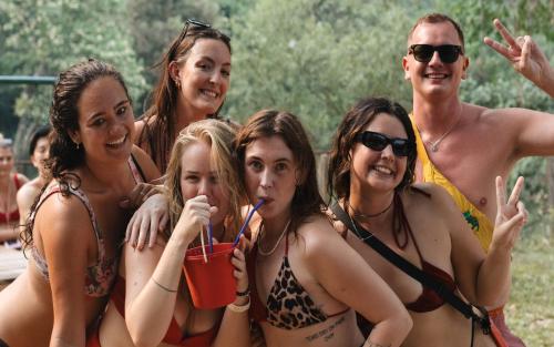a group of people in bathing suits posing for a picture at Mad Monkey Vang Vieng in Vang Vieng