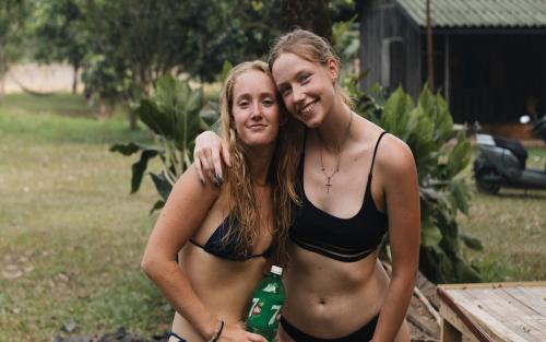 two girls in bathing suits posing for a picture at Mad Monkey Vang Vieng in Vang Vieng