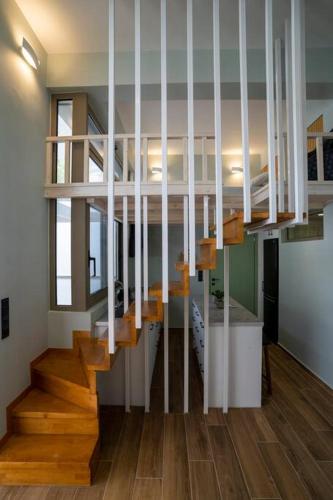 a staircase in a house with wooden floors at Oinousios in Karistos