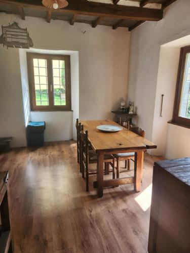 a dining room with a wooden table and chairs at Contea del Piano in Piteglio