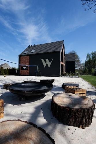 a building with aww logo on the side of it at Widać Wydmy in Łeba