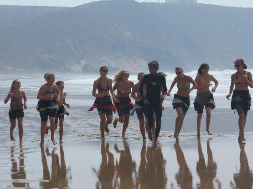 a group of people walking on the beach at Mirleft Trip in Mirleft