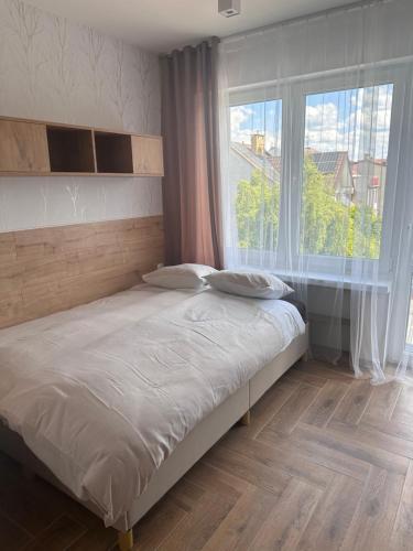 Katil atau katil-katil dalam bilik di Apartamenty W Domu DeLux