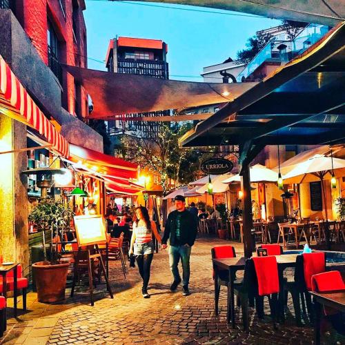 a man and a woman walking down a street at Lastarria Hotel in Santiago