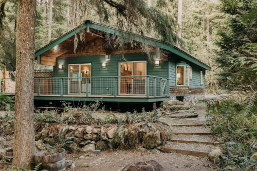 a green house in the middle of a forest at 60GS - Pets OK - Soaker Tub - Deck cabin in Glacier