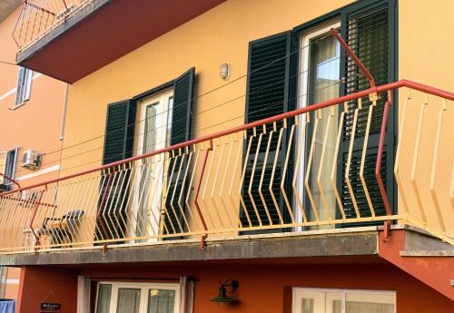 a balcony of a building with green shutters at Casa Gori in Montecatini Terme