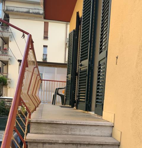 a staircase leading to a building with green shutters at Casa Gori in Montecatini Terme