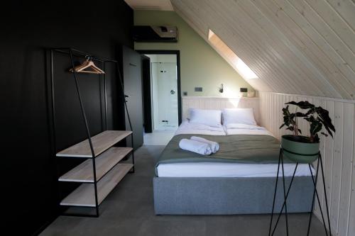 a bedroom with a bed in a attic at Widać Wydmy in Łeba