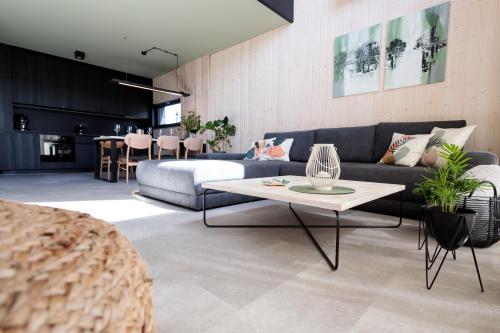 a living room with a couch and a table at Widać Wydmy in Łeba