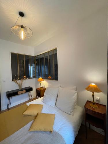- une chambre avec un lit blanc et 2 oreillers dans l'établissement Charmant appartement haut de gamme, à Salins-les-Bains