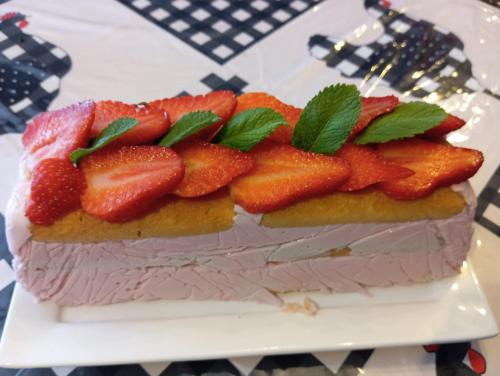 a cake with strawberries on top of it on a plate at La Gerbaudiere Chambres&Table d hotes proche Mont Saint Michel CUISINE MAISON in Notre-Dame-du-Touchet