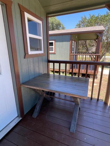 a bench on the front porch of a tiny house at Canyon Lakeview Resort in Canyon Lake