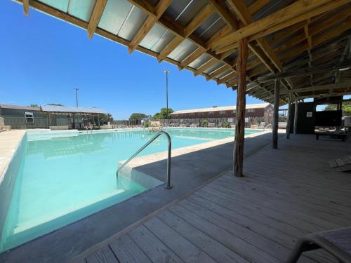 a large swimming pool with a wooden deck at Canyon Lakeview Resort in Canyon Lake