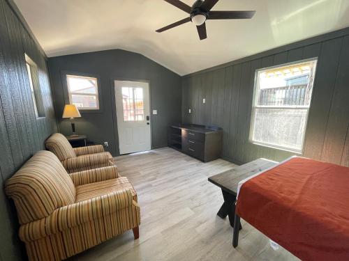 a bedroom with a ceiling fan and a couch and a bed at Canyon Lakeview Resort in Canyon Lake