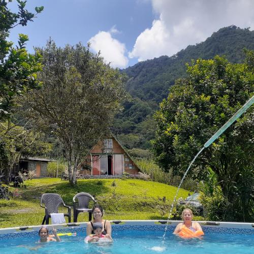 three children playing in a swimming pool with a fountain at Glamping eco descanso la vega Nocaima in Nocaima