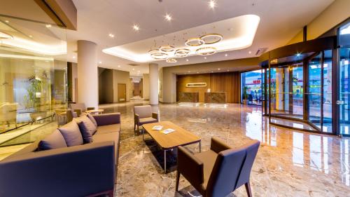 a lobby of a hotel with tables and chairs at Ada Julian Marmaris in Marmaris