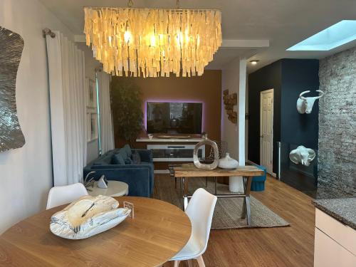 un soggiorno con tavolo e lampadario pendente di A Dedicated Space To Unwind a Brooklyn