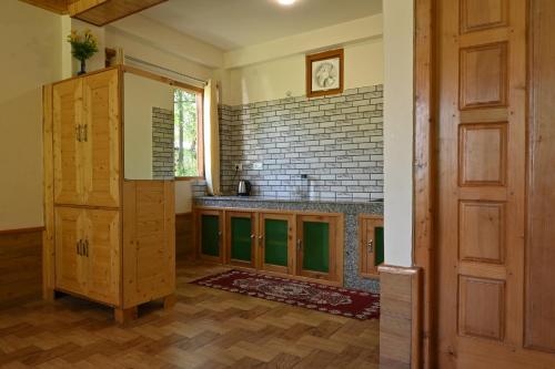 a kitchen with a sink and a counter top at Cascade Mountain Retreat Manali in Manāli