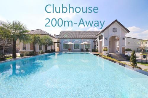 a swimming pool in front of a house at H3, Fast Wi-Fi, Safari World in Bang Khen