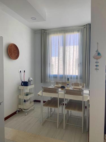 a dining room with a table and a window at Casa Seagull in Playa Blanca