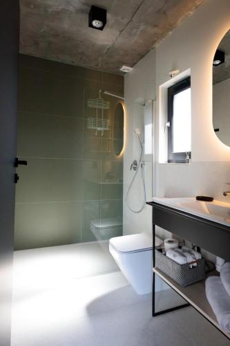 a bathroom with a shower and a sink and a toilet at Widać Wydmy in Łeba