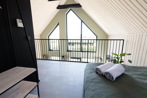 a room with a bed and a large window at Widać Wydmy in Łeba