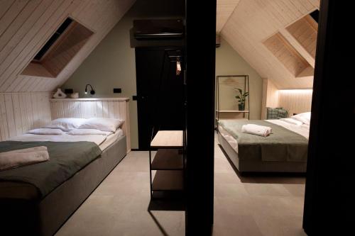 a bedroom with two beds in a attic at Widać Wydmy in Łeba
