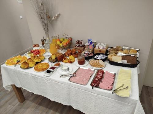 a table with many different types of food on it at Rua Grande Hotel in Viana do Castelo